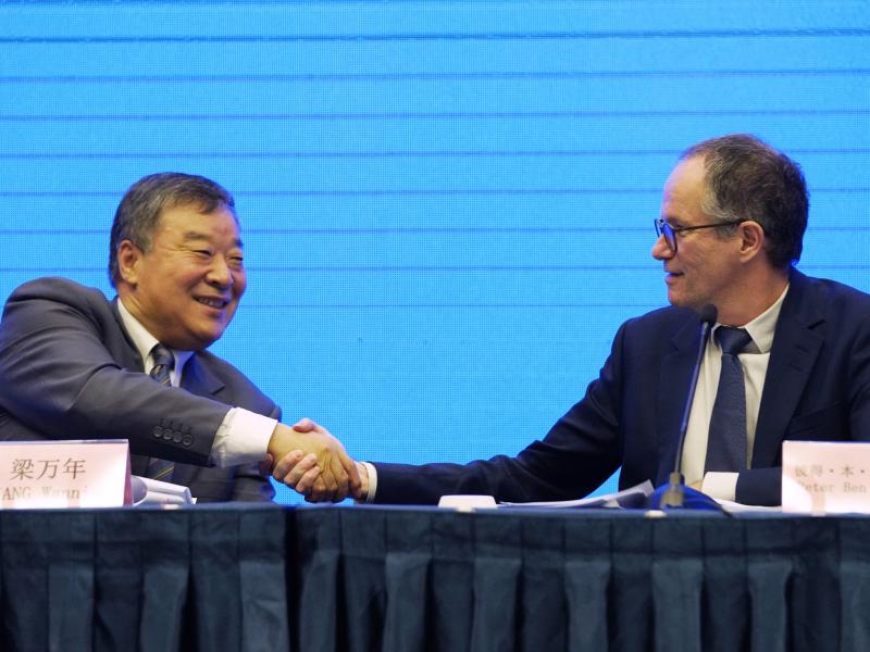 Peter Ben Embarek, of the World Health Organization team (right) shakes hands with Liang Wannian, his Chinese counterpart, after a news conference on Tuesday in Wuhan, China. The White House says it has "deep concerns" over how initial findings were commu Peter Ben Embarek, of the World Health Organization team (right) shakes hands with Liang Wannian, his Chinese counterpart, after a news conference on Tuesday in Wuhan, China. The White House says it has "deep concerns" over how initial findings were commu