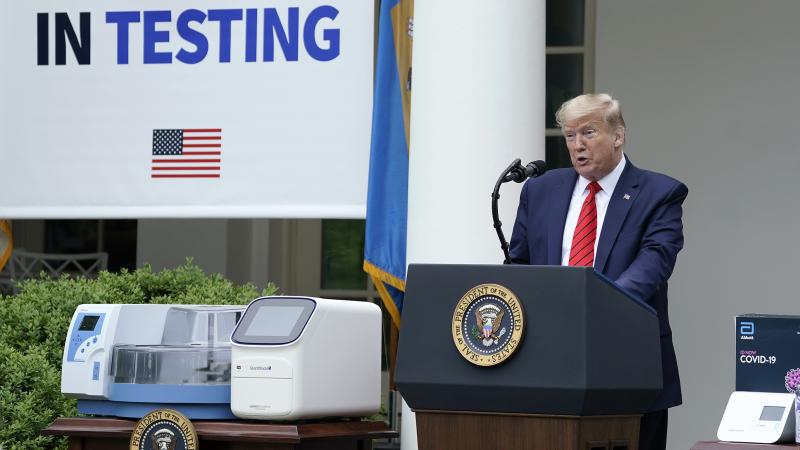 President Donald Trump, flanked by tables holding testing supplies and machines, speaks during a press briefing about coronavirus testing in the Rose Garden of the White House on May 11, 2020 in Washington, D.C. President Donald Trump, flanked by tables holding testing supplies and machines, speaks during a press briefing about coronavirus testing in the Rose Garden of the White House on May 11, 2020 in Washington, D.C.