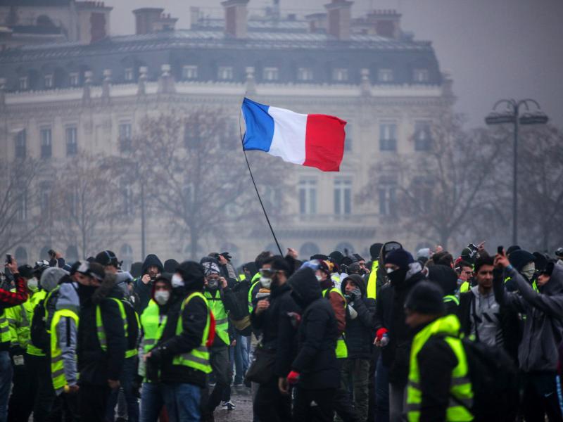 Demonstrators gather near the Arc de Triomphe in Paris during a protest on Saturday. Demonstrators gather near the Arc de Triomphe in Paris during a protest on Saturday.