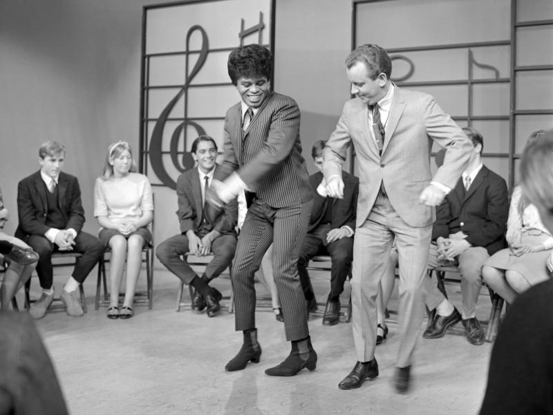 James Brown performs at KCOP Studios on the Lloyd Thaxton Show with Lloyd Thaxton in 1964. Brown helped popularize boogaloo-style dancing, shown here. James Brown performs at KCOP Studios on the Lloyd Thaxton Show with Lloyd Thaxton in 1964. Brown helped popularize boogaloo-style dancing, shown here.