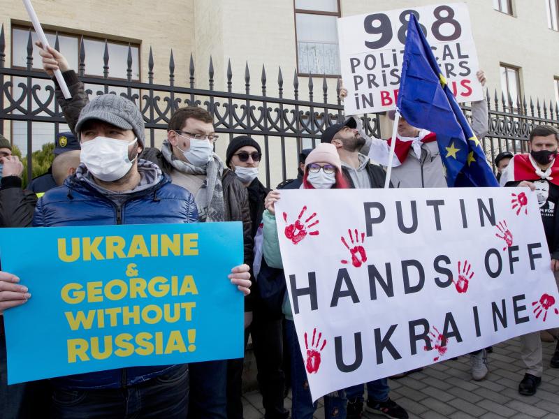 Georgian activists hold posters as they gather in support of Ukraine in front of the Ukrainian Embassy in Tbilisi, Georgia on Sunday, Jan. 23. The British government on Saturday accused Russia of seeking to replace Ukraine's government with a pro-Moscow a Georgian activists hold posters as they gather in support of Ukraine in front of the Ukrainian Embassy in Tbilisi, Georgia on Sunday, Jan. 23. The British government on Saturday accused Russia of seeking to replace Ukraine's government with a pro-Moscow a