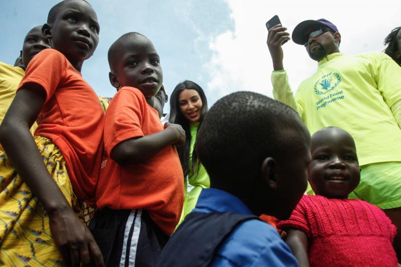 Kanye West wore a Balenciaga shirt with the World Food Programme's logo on it while visiting an orphanage near Kampala, Uganda, in October 2018. On this trip, he gifted bags full of his $220 Yeezy sneakers to the children. Kanye West wore a Balenciaga shirt with the World Food Programme's logo on it while visiting an orphanage near Kampala, Uganda, in October 2018. On this trip, he gifted bags full of his $220 Yeezy sneakers to the children.
