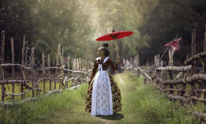 In Voyages of an African Victorian, a woman wears a Victorian-style dress made of African fabrics. In Voyages of an African Victorian, a woman wears a Victorian-style dress made of African fabrics.