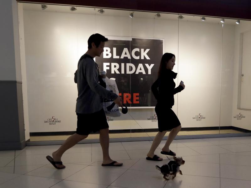 Shoppers walk past a Saks Fifth Avenue outlet store in Miami on Black Friday. Millennials have lower earnings, fewer assets and less wealth, a new Federal Reserve study says. Shoppers walk past a Saks Fifth Avenue outlet store in Miami on Black Friday. Millennials have lower earnings, fewer assets and less wealth, a new Federal Reserve study says.