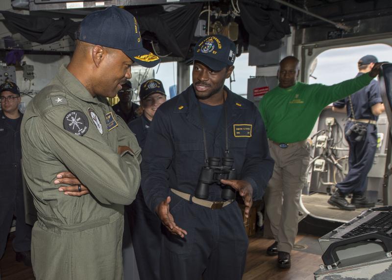 Rear Adm. Alvin Holsey (left) speaks with Ensign Dimitri Foster in the pilothouse aboard guided-missile cruiser USS Lake Champlain in 2018. Rear Adm. Alvin Holsey (left) speaks with Ensign Dimitri Foster in the pilothouse aboard guided-missile cruiser USS Lake Champlain in 2018.