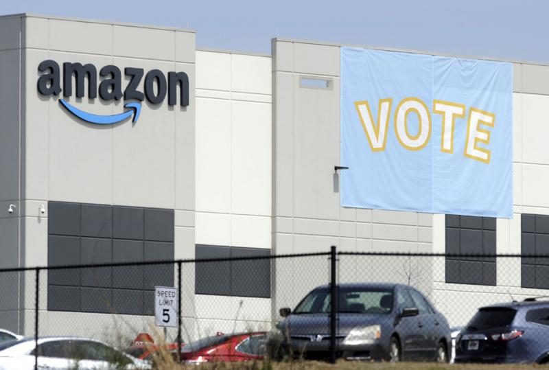 A banner encourages workers to vote in a union election at Amazon's warehouse in Bessemer, Ala. A banner encourages workers to vote in a union election at Amazon's warehouse in Bessemer, Ala.