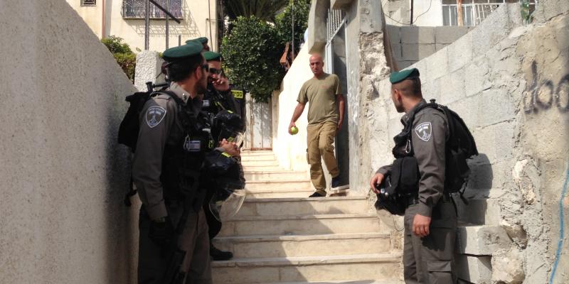 Israeli police stand near a residence in East Jerusalem where Israeli Jews have bought apartments in the predominantly Palestinian neighborhood of Silwan. The Palestinian seller said he sold the apartment to a Palestinian middleman and did not realize the Israeli police stand near a residence in East Jerusalem where Israeli Jews have bought apartments in the predominantly Palestinian neighborhood of Silwan. The Palestinian seller said he sold the apartment to a Palestinian middleman and did not realize the