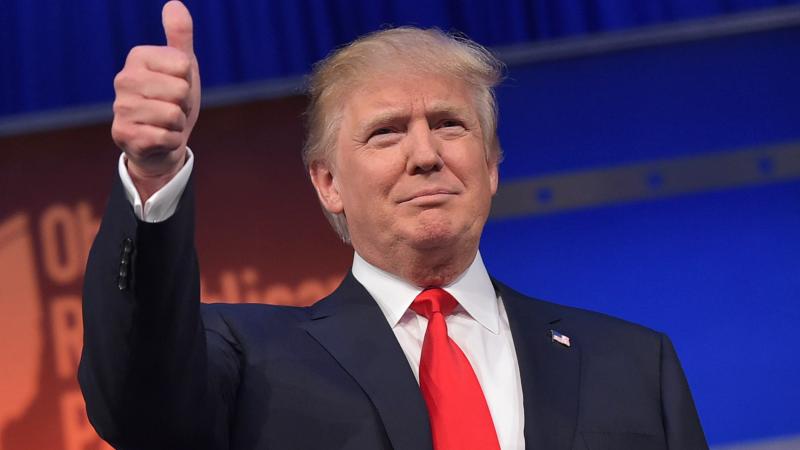 Donald Trump flashes the thumbs-up as he arrives on stage for the start of the prime time Republican presidential debate on August 6, 2015. Donald Trump flashes the thumbs-up as he arrives on stage for the start of the prime time Republican presidential debate on August 6, 2015.