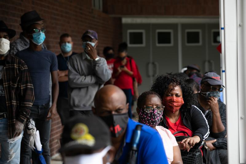 People wait in line on the first day of early voting for the 2020 general election on Oct. 12 in Atlanta. People wait in line on the first day of early voting for the 2020 general election on Oct. 12 in Atlanta.