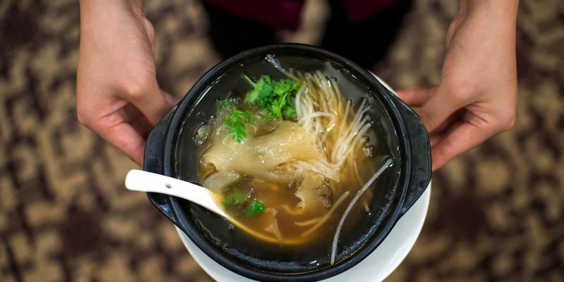 A waitress serves shark fin soup in a restaurant in Guangzhou, in southern China's Guangdong province on Aug. 10, 2014. A waitress serves shark fin soup in a restaurant in Guangzhou, in southern China's Guangdong province on Aug. 10, 2014.