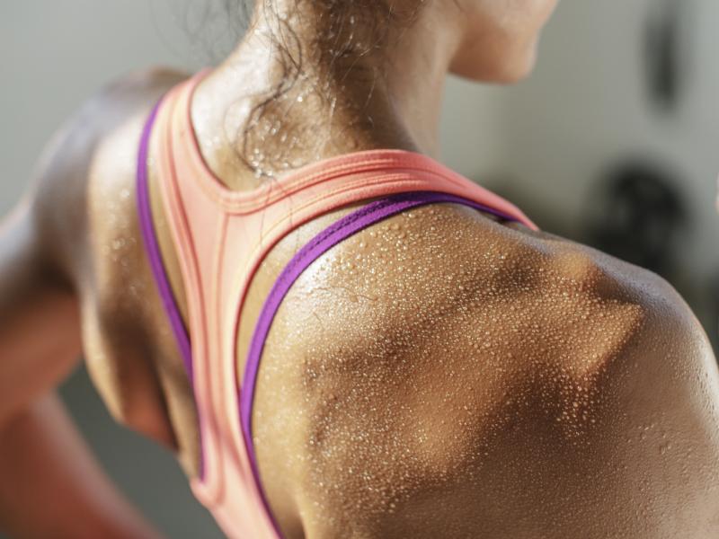 A woman sweats while working out. A woman sweats while working out.