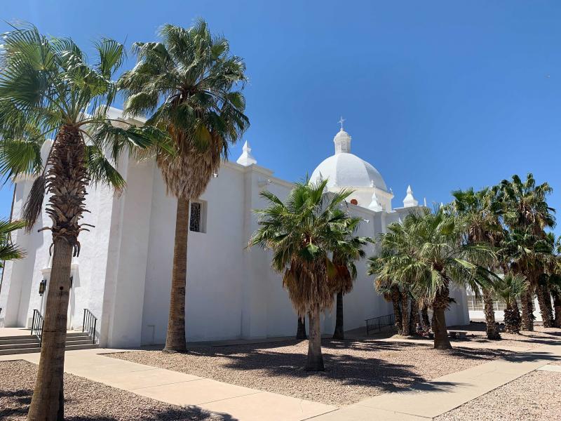 Ajo, a former copper mining town more than 100 miles from Phoenix, is unincorporated. The U.S. government began dropping off migrants on the historic plaza in Ajo in March. Ajo, a former copper mining town more than 100 miles from Phoenix, is unincorporated. The U.S. government began dropping off migrants on the historic plaza in Ajo in March.