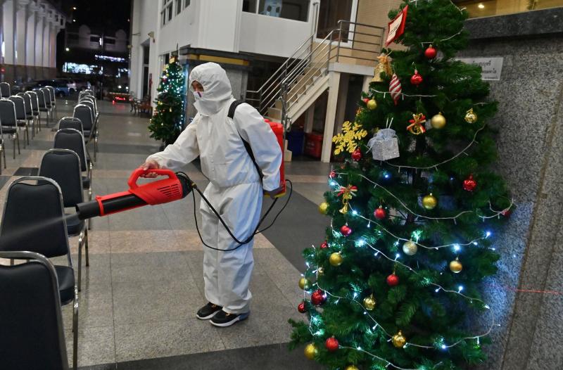A worker wearing personal protective equipment disinfects the Holy Redeemer Church in Bangkok after a Christmas Eve mass. Thailand is one of many countries now seeing a surge in cases. A worker wearing personal protective equipment disinfects the Holy Redeemer Church in Bangkok after a Christmas Eve mass. Thailand is one of many countries now seeing a surge in cases.