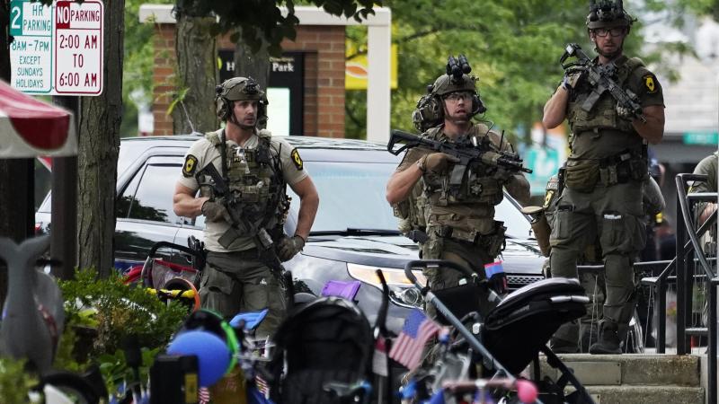 Law enforcement personnel secure the scene after a mass shooting Monday at a Fourth of July parade in downtown Highland Park, a Chicago suburb. Law enforcement personnel secure the scene after a mass shooting Monday at a Fourth of July parade in downtown Highland Park, a Chicago suburb.