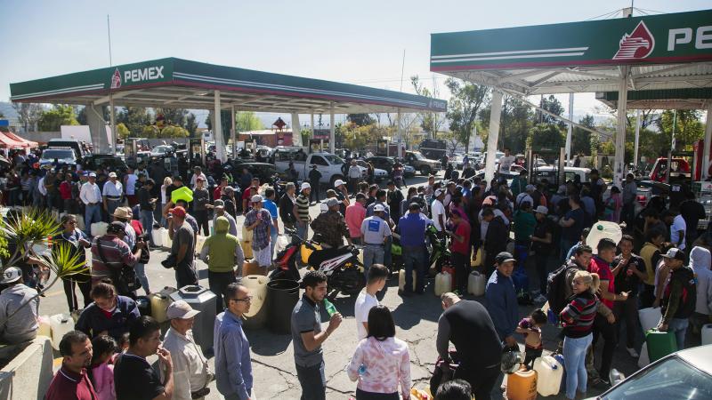 People line up to buy gasoline at a gas station in Morelia, Michoacan, on Jan. 8. Michaocan is one of several Mexican states where fuel shortages have been reported. People line up to buy gasoline at a gas station in Morelia, Michoacan, on Jan. 8. Michaocan is one of several Mexican states where fuel shortages have been reported.