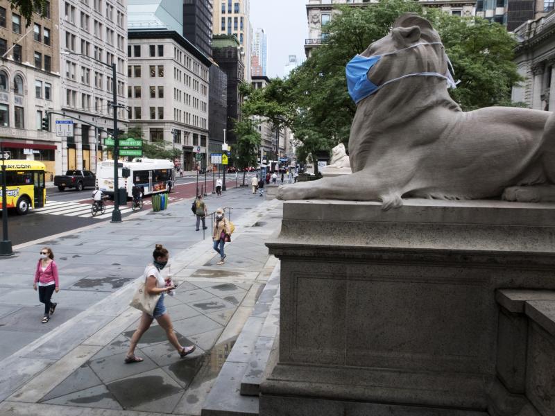 A face mask covers the mouth and nose of one of the iconic lion statues in front of the New York Public Library Main Branch on Wednesday, July 1, 2020, in New York, amid the coronavirus pandemic. A face mask covers the mouth and nose of one of the iconic lion statues in front of the New York Public Library Main Branch on Wednesday, July 1, 2020, in New York, amid the coronavirus pandemic.