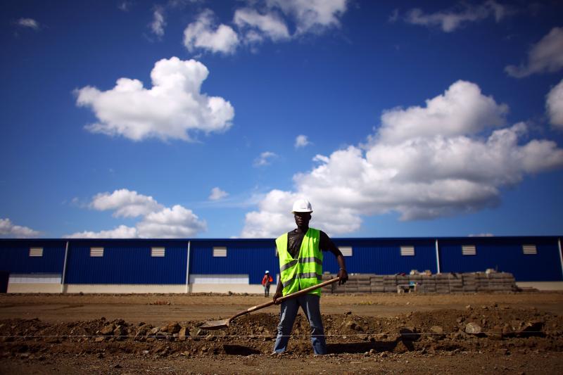 Workers prepare the foundation for a new warehouse and manufacturing facility at the Caracol Industrial Park in northern Haiti. The park, which opened last year, is still under construction. Workers prepare the foundation for a new warehouse and manufacturing facility at the Caracol Industrial Park in northern Haiti. The park, which opened last year, is still under construction.