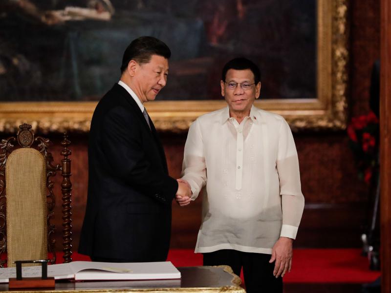 Chinese President Xi Jinping (left) shakes hands with Philippine President Rodrigo Duterte after a guest book signing at the Malacañang presidential palace in Manila on Tuesday. Duterte called Xi's visit to longtime U.S. ally the Philippines a "milestone Chinese President Xi Jinping (left) shakes hands with Philippine President Rodrigo Duterte after a guest book signing at the Malacañang presidential palace in Manila on Tuesday. Duterte called Xi's visit to longtime U.S. ally the Philippines a "milestone
