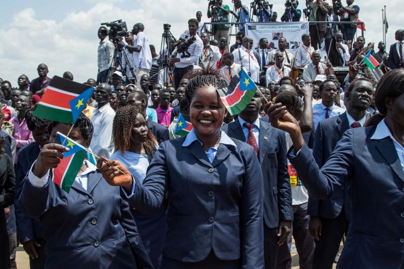 People waved the national flags of South Sudan during a peace ceremony in the capital city of Juba last Thursday. South Sudan rebel leader Riek Machar returned to Juba after two years of exile, saying he had come bearing a message of peace. People waved the national flags of South Sudan during a peace ceremony in the capital city of Juba last Thursday. South Sudan rebel leader Riek Machar returned to Juba after two years of exile, saying he had come bearing a message of peace.