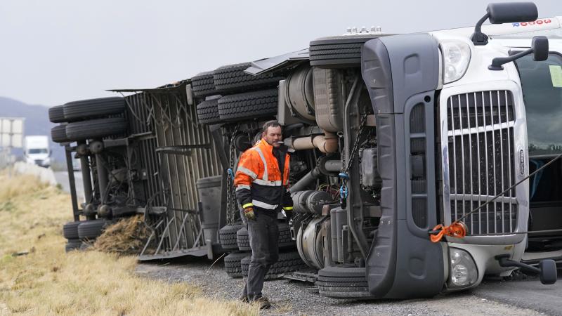 A semi rests in its side after after high winds toppled it on Interstate 15 near Bountiful, Utah, Tuesday. A semi rests in its side after after high winds toppled it on Interstate 15 near Bountiful, Utah, Tuesday.