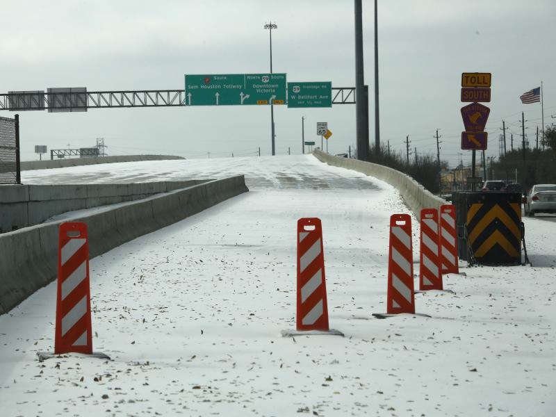 A highway on-ramp in Houston is closed due to snow and ice on Monday. Frigid temperatures, icy roads and power outages caused by a major winter storm have interfered with COVID-19 vaccine distribution in Texas and several other states. A highway on-ramp in Houston is closed due to snow and ice on Monday. Frigid temperatures, icy roads and power outages caused by a major winter storm have interfered with COVID-19 vaccine distribution in Texas and several other states.