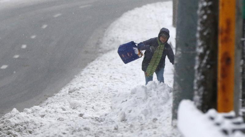 A person stumbles through deep snow Monday in Marlborough, Mass. A person stumbles through deep snow Monday in Marlborough, Mass.