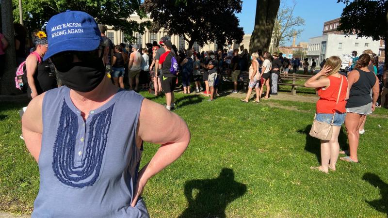 Wearing a mask to protect herself from the coronavirus and a hat that reads "Make Racism Wrong Again," Lydia Spottswood joins a protest in Kenosha, Wis., in response to George Floyd's killing by police. She thinks people are tired of President Trump's "me Wearing a mask to protect herself from the coronavirus and a hat that reads "Make Racism Wrong Again," Lydia Spottswood joins a protest in Kenosha, Wis., in response to George Floyd's killing by police. She thinks people are tired of President Trump's "me