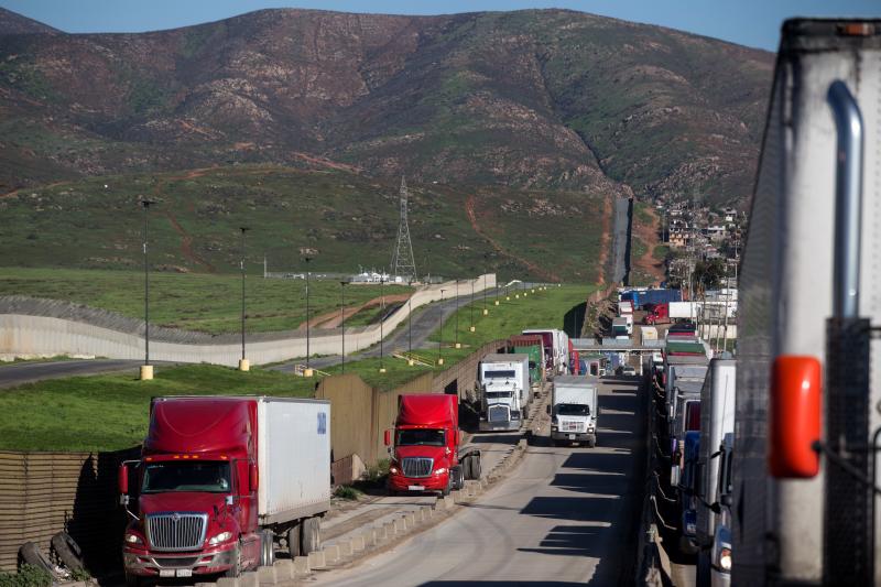 Trucks line up to cross to the United States near the Otay Commercial port of entry on the Mexican side of the U.S.-Mexico border on Jan. 25. Trump now says he will renegotiate the North American Free Trade Agreement, which he has long criticized, rather Trucks line up to cross to the United States near the Otay Commercial port of entry on the Mexican side of the U.S.-Mexico border on Jan. 25. Trump now says he will renegotiate the North American Free Trade Agreement, which he has long criticized, rather