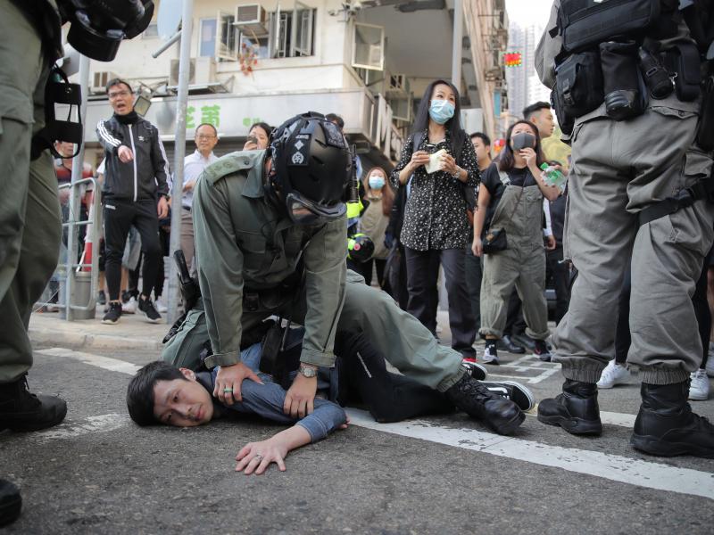 A protester is detained in Hong Kong Nov. 11, 2019. Hong Kong is in the sixth month of protests that began in June over a proposed extradition law and grown to include other grievances. A protester is detained in Hong Kong Nov. 11, 2019. Hong Kong is in the sixth month of protests that began in June over a proposed extradition law and grown to include other grievances.