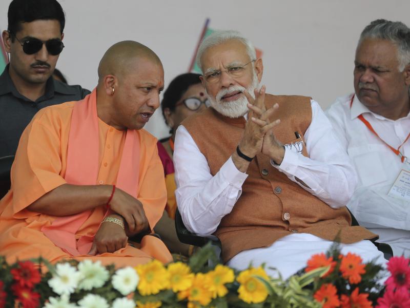 Indian Prime Minister Narendra Modi speaks with of Yogi Adityanath (left), a Hindu priest who is chief minister of Uttar Pradesh, during a campaign rally on March 28. Indian Prime Minister Narendra Modi speaks with of Yogi Adityanath (left), a Hindu priest who is chief minister of Uttar Pradesh, during a campaign rally on March 28.