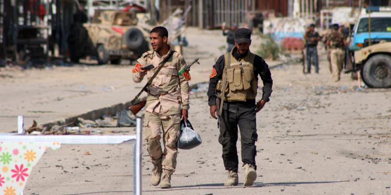 Iraqi soldiers walk in Jurf al-Sakhr, south of the capital Baghdad, on Monday after Iraqi military forces retook the area from Islamic State militants. Iraqi forces, supported by U.S. airstrikes, have made limited gains in recent months, but critics are q Iraqi soldiers walk in Jurf al-Sakhr, south of the capital Baghdad, on Monday after Iraqi military forces retook the area from Islamic State militants. Iraqi forces, supported by U.S. airstrikes, have made limited gains in recent months, but critics are q