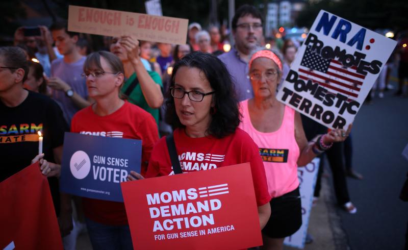 Advocates of stricter gun legislation hold a candlelight vigil for victims of recent mass shootings outside the headquarters of the National Rifle Association on Monday in Fairfax, Va. Advocates of stricter gun legislation hold a candlelight vigil for victims of recent mass shootings outside the headquarters of the National Rifle Association on Monday in Fairfax, Va.
