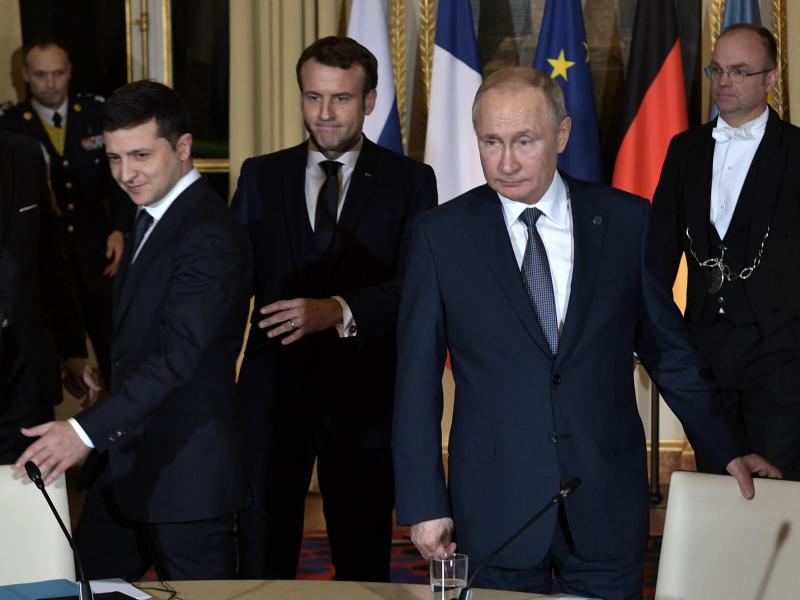Ukrainian President Volodymyr Zelenskiy, French President Emmanuel Macron and Russian President Vladimir Putin arrive for a meeting on Ukraine with German Chancellor at the Elysee Palace on Monday in Paris. Ukrainian President Volodymyr Zelenskiy, French President Emmanuel Macron and Russian President Vladimir Putin arrive for a meeting on Ukraine with German Chancellor at the Elysee Palace on Monday in Paris.