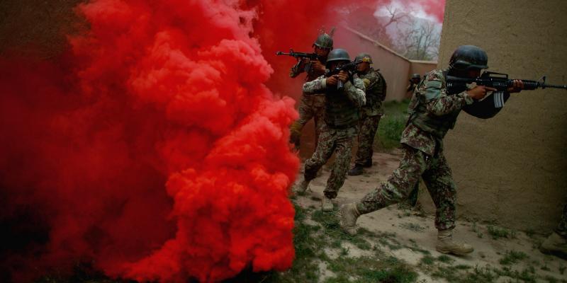 Afghan commandos move through a smokescreen during a training exercise at Camp Commando on the outskirts of Kabul, Afghanistan. Afghan commandos move through a smokescreen during a training exercise at Camp Commando on the outskirts of Kabul, Afghanistan.