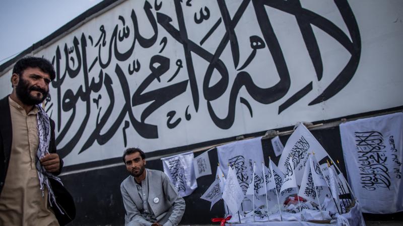 A man sells Taliban flags imprinted with the Muslim creed in Kabul, Afghanistan, on Sept. 24. A man sells Taliban flags imprinted with the Muslim creed in Kabul, Afghanistan, on Sept. 24.