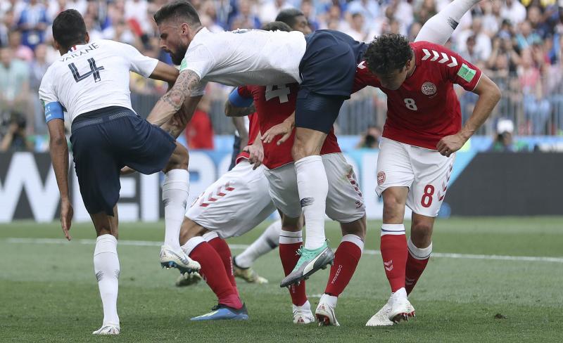 France's Olivier Giroud, center, goes down after a header during the group C match between Denmark and France at the 2018 soccer World Cup at Luzhniki Stadium in Moscow on Tuesday. The teams played to a scoreless tie — the tournament's first. France's Olivier Giroud, center, goes down after a header during the group C match between Denmark and France at the 2018 soccer World Cup at Luzhniki Stadium in Moscow on Tuesday. The teams played to a scoreless tie — the tournament's first.