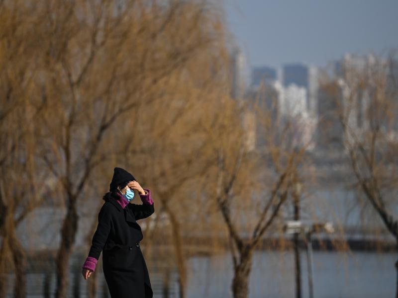 A woman walks in a park along Yangtze River in Wuhan on Jan. 19, 2021. Residents of the city of 11 million, which was the first epicenter of COVID-19, have conflicting emotions as they reckon with the aftermath of the virus and their 76-day lockdown. A woman walks in a park along Yangtze River in Wuhan on Jan. 19, 2021. Residents of the city of 11 million, which was the first epicenter of COVID-19, have conflicting emotions as they reckon with the aftermath of the virus and their 76-day lockdown.