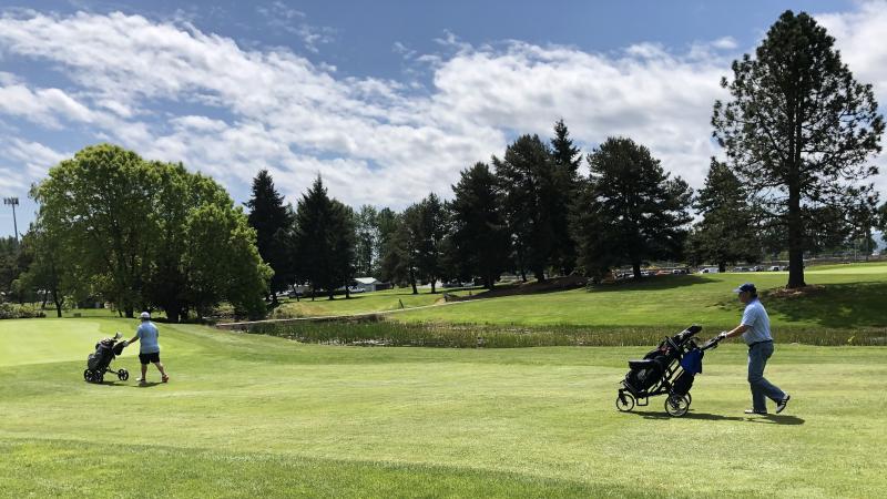Curt Fitzpatrick (left) and Ross Jepson keep their distance on Three Rivers Golf Course in Kelso, Wash. The state lifted COVID-19 restrictions on golf courses after a month-and-a-half shutdown. Curt Fitzpatrick (left) and Ross Jepson keep their distance on Three Rivers Golf Course in Kelso, Wash. The state lifted COVID-19 restrictions on golf courses after a month-and-a-half shutdown.