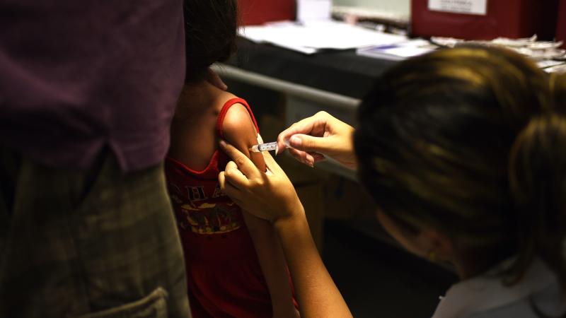 A girl is vaccinated against yellow fever in Rio de Janeiro. A girl is vaccinated against yellow fever in Rio de Janeiro.