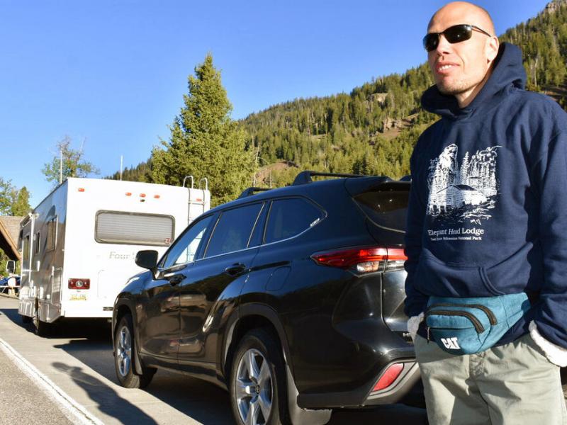 Muris Demirovic waits by his rental car outside Yellowstone National Park for the entrance gate to open on Wednesday morning, near Wapiti, Wyo. Muris Demirovic waits by his rental car outside Yellowstone National Park for the entrance gate to open on Wednesday morning, near Wapiti, Wyo.