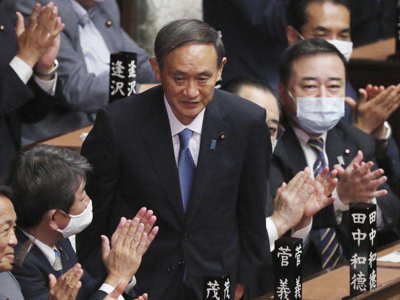 Yoshihide Suga receives applause Wednesday after being elected as Japan's new prime minister at Parliament's lower house in Tokyo. Yoshihide Suga receives applause Wednesday after being elected as Japan's new prime minister at Parliament's lower house in Tokyo.