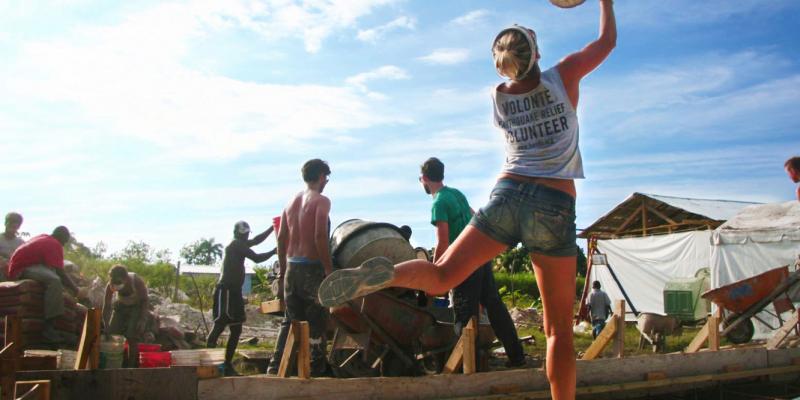 In Haiti after the earthquake, volunteers with All Hands toss buckets from the cement mixer back to the sand piles for a quick refill. In Haiti after the earthquake, volunteers with All Hands toss buckets from the cement mixer back to the sand piles for a quick refill.