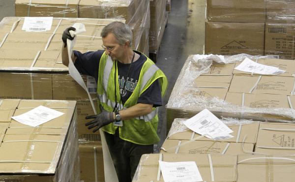 A dock clerk labels boxes as they arrive at an Amazon.com fulfillment center in Phoenix. A dock clerk labels boxes as they arrive at an Amazon.com fulfillment center in Phoenix.