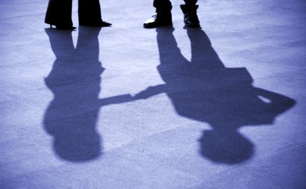 A businesswoman and businessman shake hands. A businesswoman and businessman shake hands.