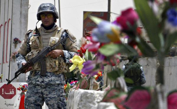 An Iraqi policeman stands guard at a checkpoint decorated with plastic flowers in Baghdad in 2008. An Iraqi policeman stands guard at a checkpoint decorated with plastic flowers in Baghdad in 2008.