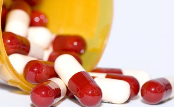 Oxycodone pills spill out of a pillbox Oxycodone pills spill out of a pillbox