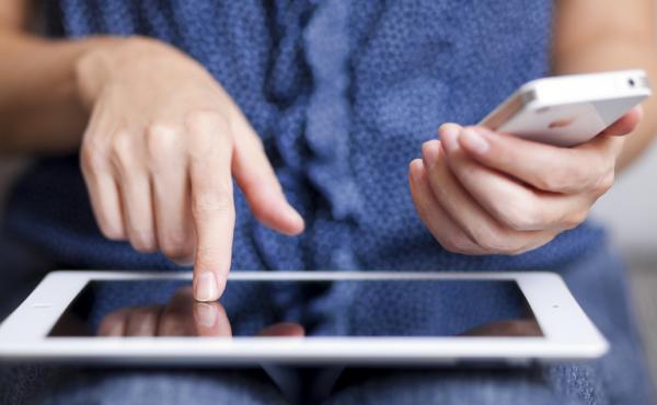 A woman uses a new iPad and iPhone 4 in the office. Nizhnevartovsk, Russia, Sept. 16, 2012. A woman uses a new iPad and iPhone 4 in the office. Nizhnevartovsk, Russia, Sept. 16, 2012.