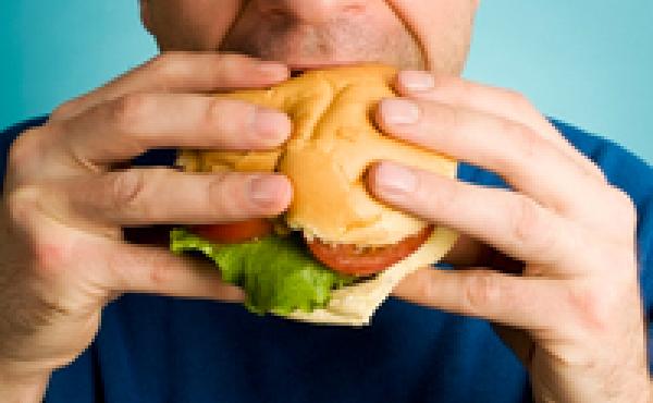 Man eats a hamburger Man eats a hamburger
