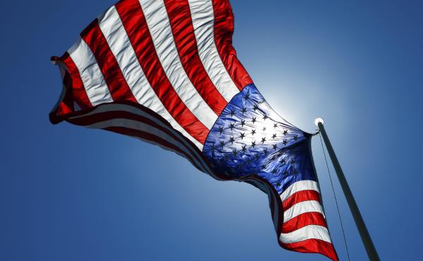 An American flag waves in the sky. An American flag waves in the sky.