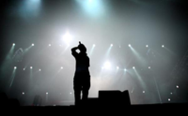 A teen sings on stage. A teen sings on stage.